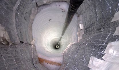 deep hole being drilled into ice